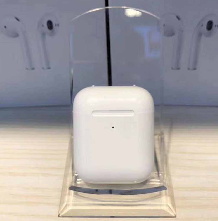 i80 TWS Bluetooth Earbuds with Wireless Charging displayed in a showcase, highlighting their sleek design.