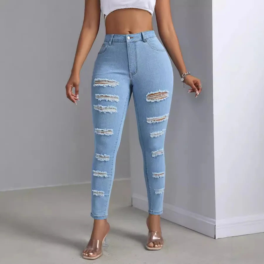 Fashion Personality Women's Ripped Jeans Trousers in light blue with stylish distressed details.