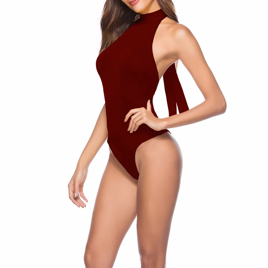 Backless Strappy Irregular Jumpsuit in burgundy color on a model showcasing a unique design and style.