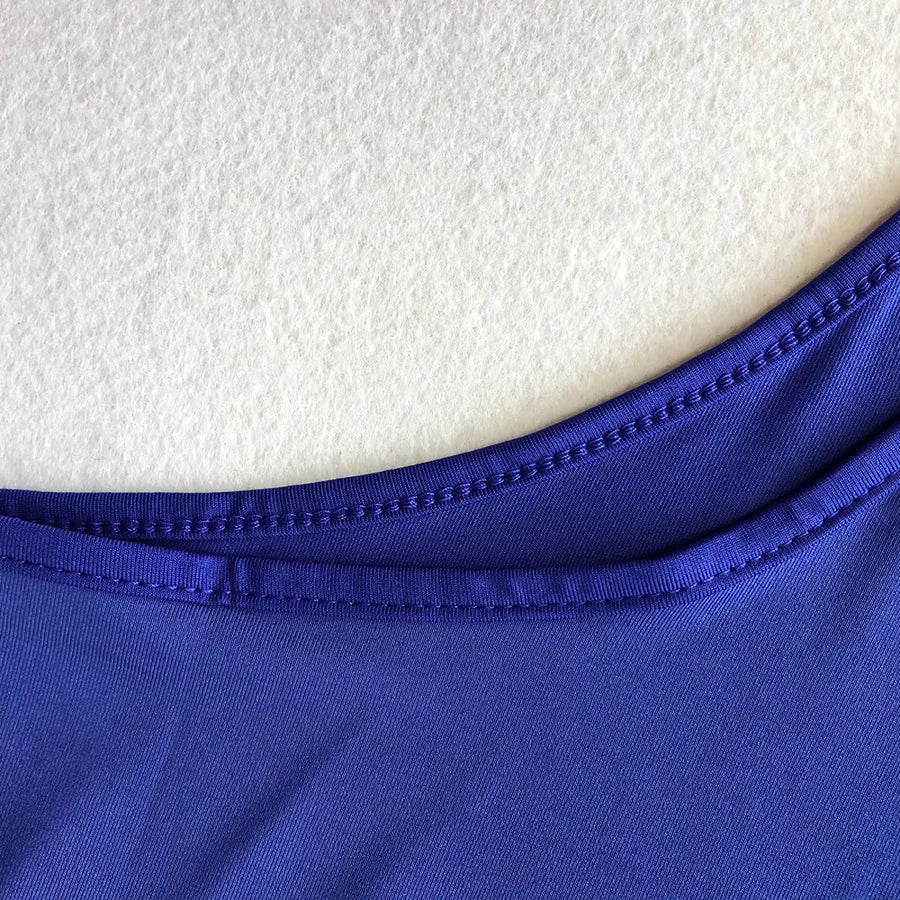Backless Strappy Irregular Jumpsuit neckline detail in vibrant purple fabric.